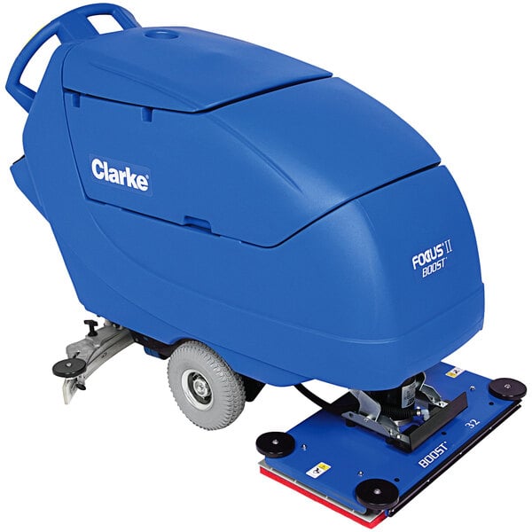 A close-up of a blue Clarke Focus II BOOST32 walk-behind floor scrubber machine with wheels.