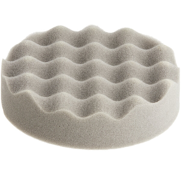 A grey foamy sponge with a wavy pattern on it.