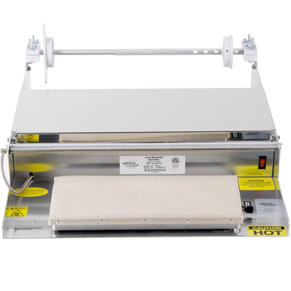A white rectangular Winholt film wrapping machine with a metal frame.