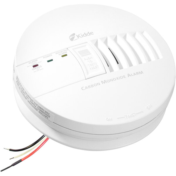A white Kidde hardwired interconnectable circular carbon monoxide alarm with wires and buttons.