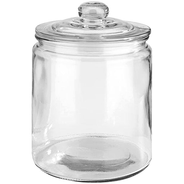 An APS Classic clear glass canister with a lid.