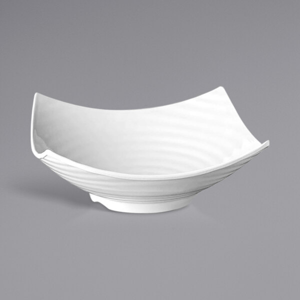 A white APS Global square melamine bowl with curved edges.