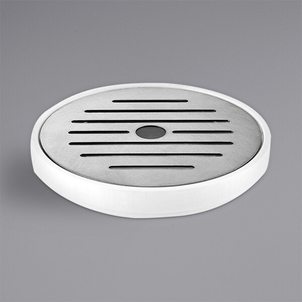 A round white stainless steel drip tray with black lines and circular holes.