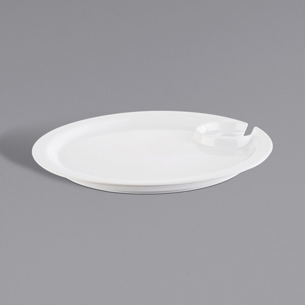 A white APS round cocktail plate with a fork on it.