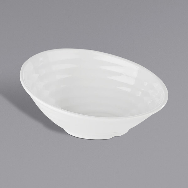 A white APS Global melamine bowl on a gray surface.
