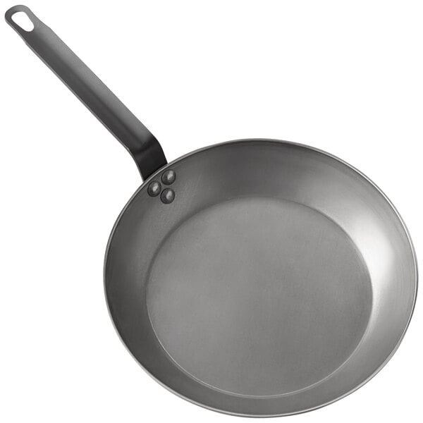 An American Metalcraft carbon steel frying pan with a black handle.
