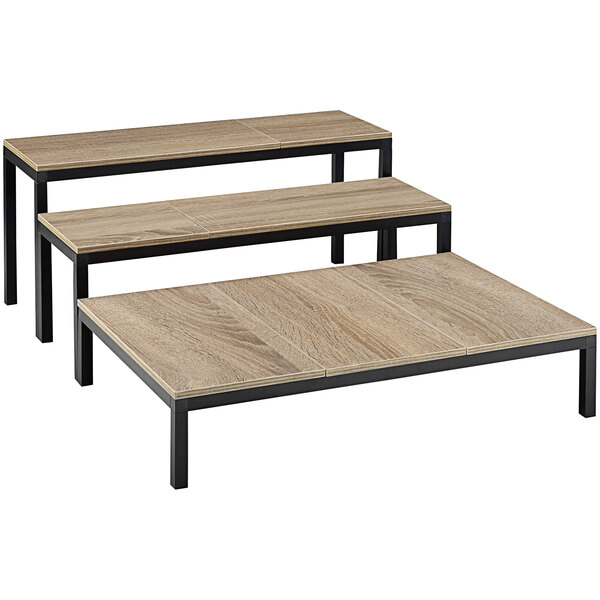 A group of wood tables with Abert Revolution risers on one table.