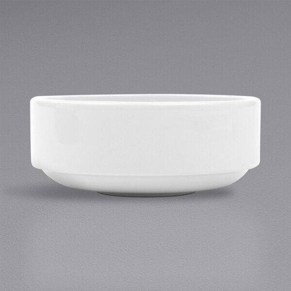 A stackable bright white porcelain bouillon bowl on a gray background.