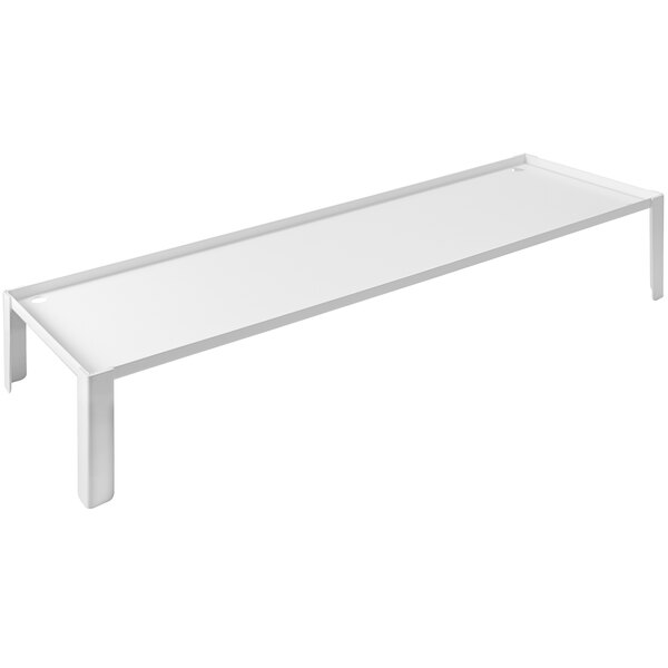 A white rectangular buffet podium on a white table.