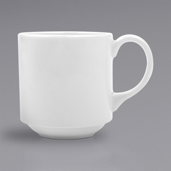 A close-up of a bright white porcelain tea mug with a handle.