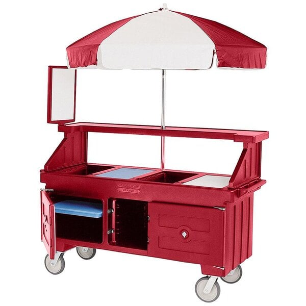 A red and white food cart with an umbrella.