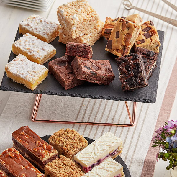 A Sweet Street Desserts tray of assorted dessert bars on a table.