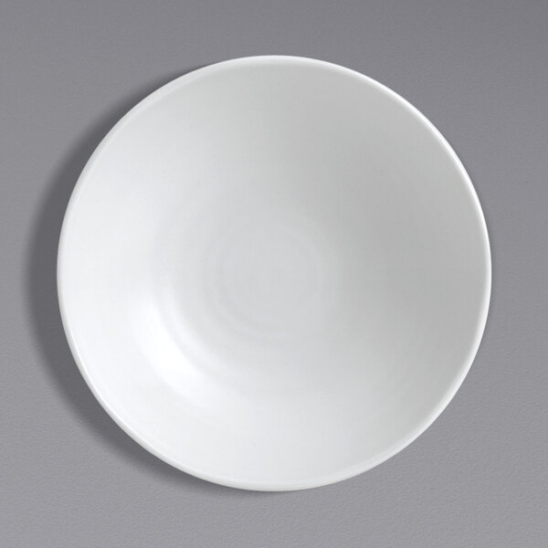 A Dudson Organic White china plate with a white rim on a gray surface.