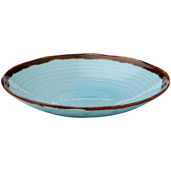 A turquoise bowl with a brown rim.