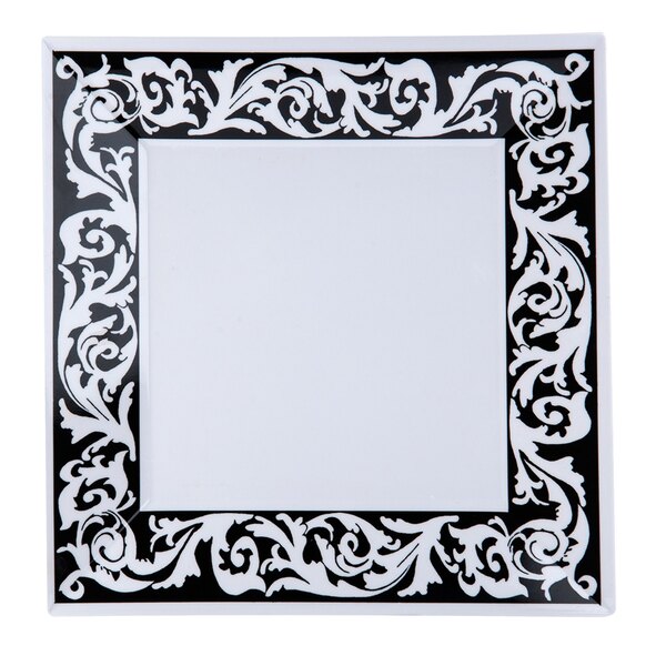 A black and white square plate with a decorative design.