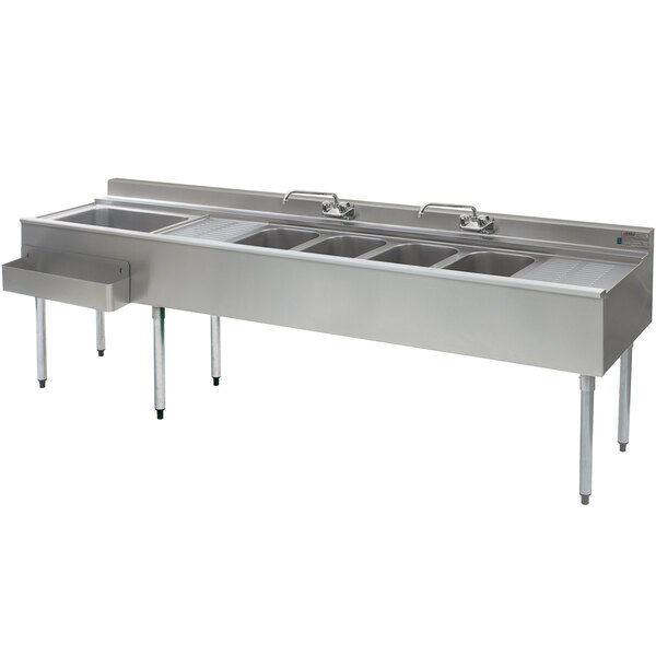 A stainless steel Eagle Group underbar sink with four compartments, two drainboards, and a left side ice bin.