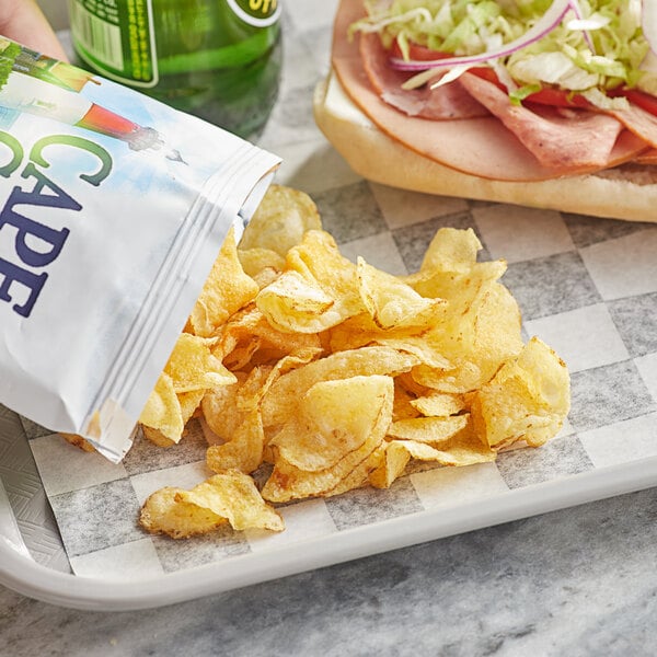 A tray with a sandwich and a bag of Cape Cod Less Fat Original Sea Salt Kettle Cooked Potato Chips.