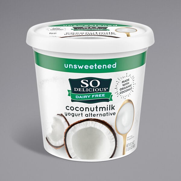 A container of So Delicious Dairy-Free Unsweet Plain Coconut Milk Yogurt with a spoon inside.