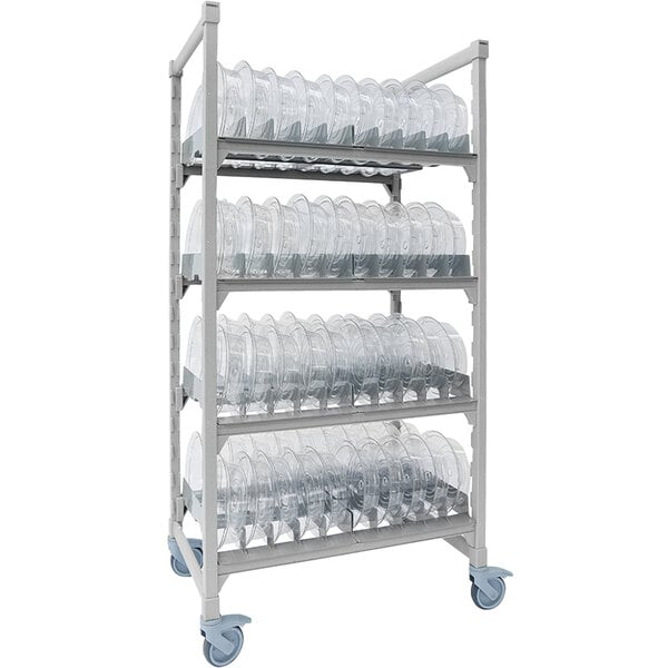 A white Cambro Camshelving® Premium rack with clear plastic dome cradle shelves holding plastic containers.