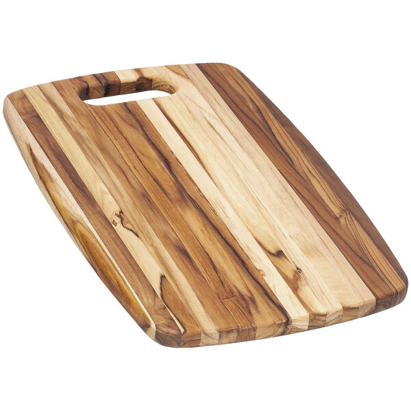 A Teakhaus teakwood cutting board with a hole handle.