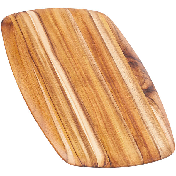 A Teakhaus teakwood serving board with a rounded edge and handle.