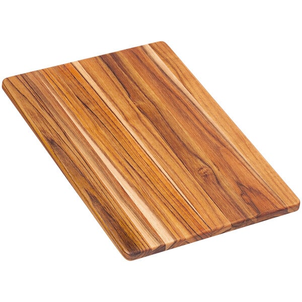 A Teakhaus edge grain teakwood cutting board with a wooden handle.