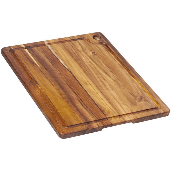 A Teakhaus wooden cutting board with a handle and hole.