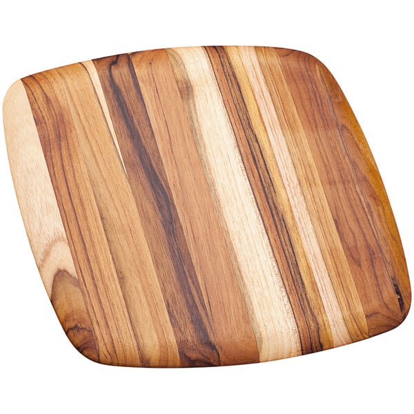 A Teakhaus teakwood serving board with a square shape and rounded edge.