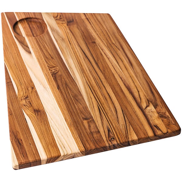 A Teakwood cutting board with a bowl insert in the middle.