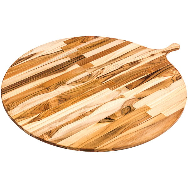 A Teakhaus teakwood round serving board with a handle on a wood table.