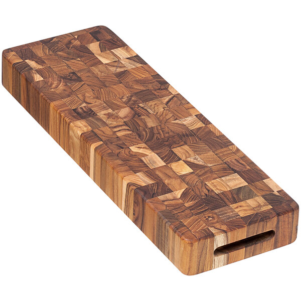 A Teakhaus end grain teakwood cutting board with a rectangular shape and a hole in the corner.
