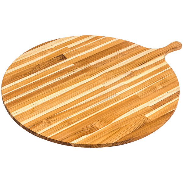 A Teakhaus teakwood round serving board with a handle on a wood surface.