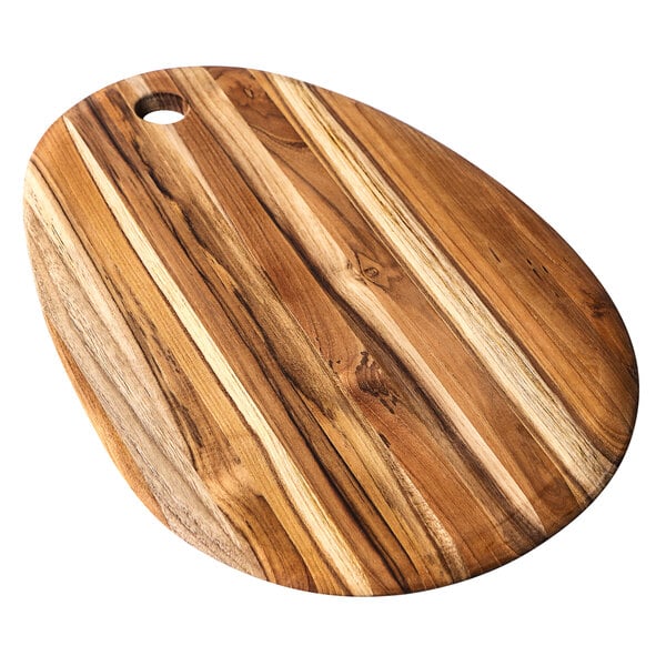 A Teakhaus oval teakwood serving board with a hanging hole.