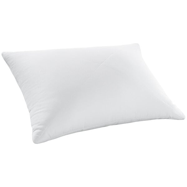 A Restful Nights white synthetic hotel pillow on a white surface.