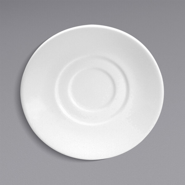 A close-up of a Oneida white bone china saucer with a circular rim.