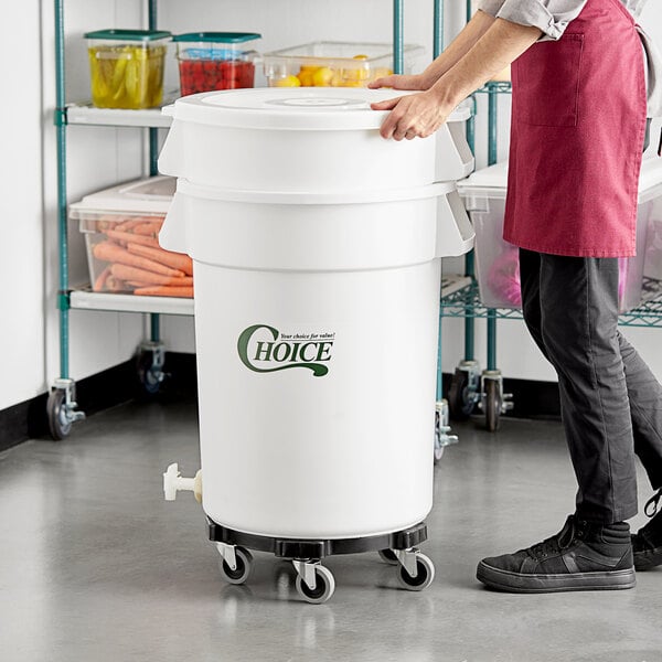 A man pushing a large white Choice vegetable crisper bin with a green lid.
