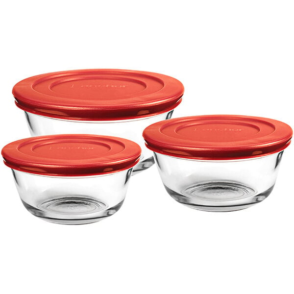 A set of three Anchor Hocking glass mixing bowls with red plastic lids.