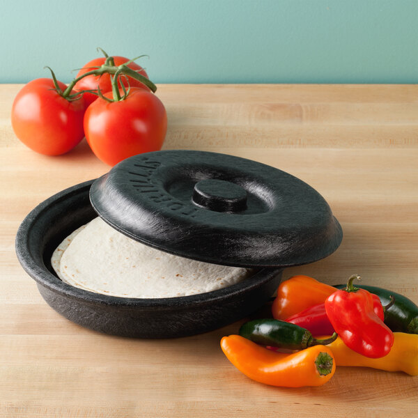 A black cast iron skillet with a tortilla inside.