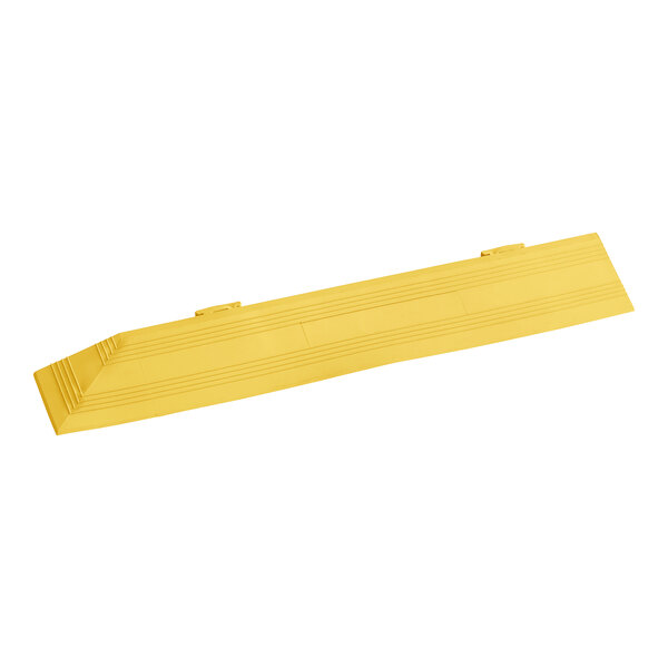 A yellow rectangular Cactus Mat corner ramp with lines on it.