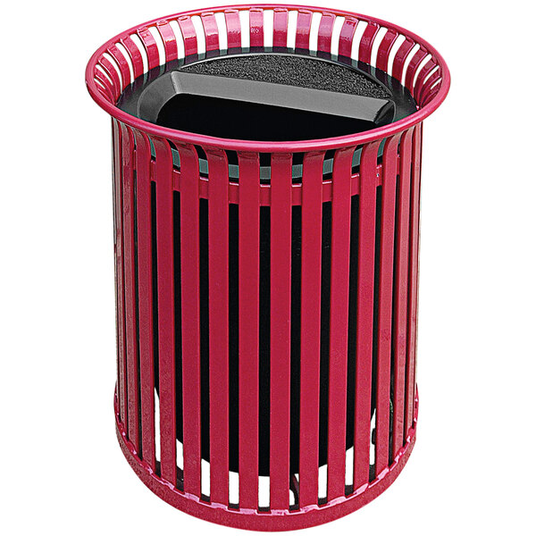 A red Wausau Tile metal outdoor trash receptacle with a black lid and rim.