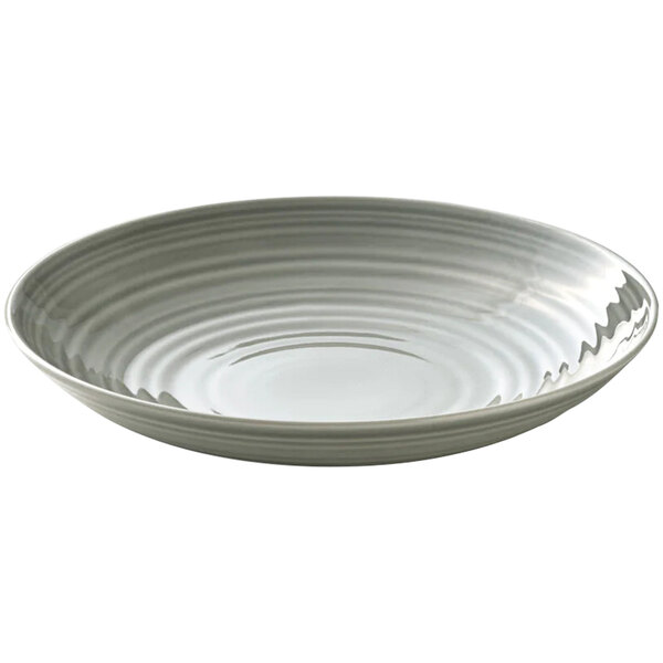 A white porcelain deep coupe plate with a curved edge and ripples on the surface with a gray rim.