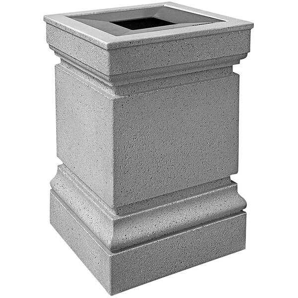 A Wausau Tile Cartier concrete trash receptacle with an aluminum lid on an outdoor patio.