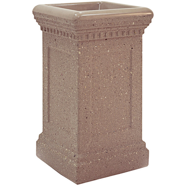 A brown square concrete ash receptacle with a decorative design on a square base.