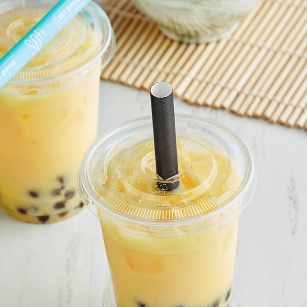 Two plastic cups of yellow boba tea with black SOFi paper straws.