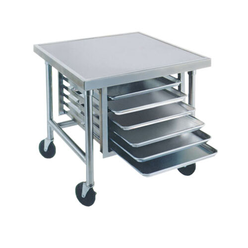 An Advance Tabco stainless steel mixer table with galvanized tray slides holding four trays.