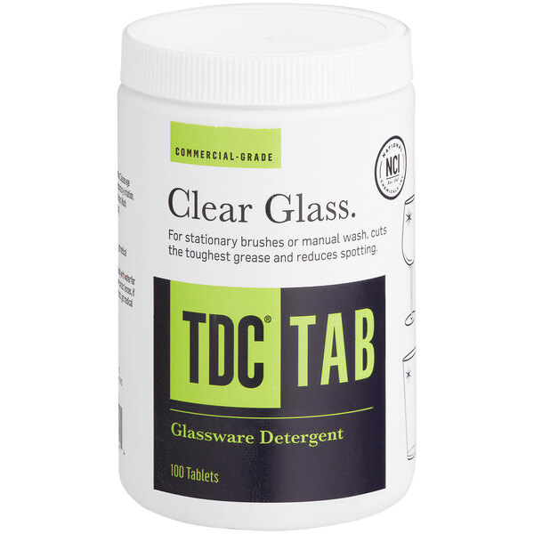 A white National Chemicals TDC Manual Bar Glass Detergent tablet with a black and green label.