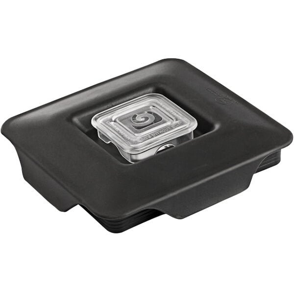 A black plastic Blendtec latching lid with a square spiral design inside.