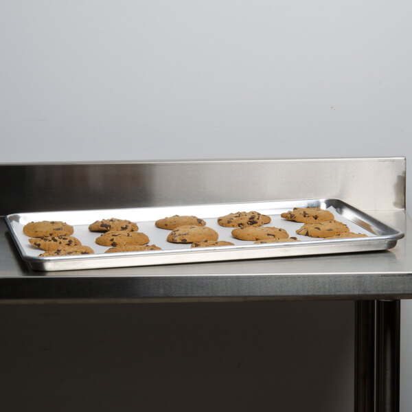 A Carlisle bun pan with cookies on a table.