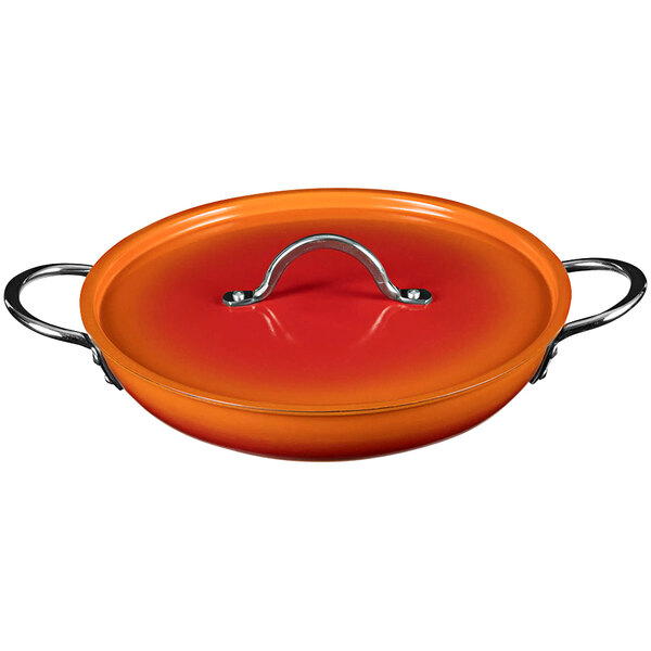 A Bon Chef Ombre Tangerine saute pan with a metal lid.