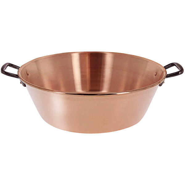 A copper pot with handles.